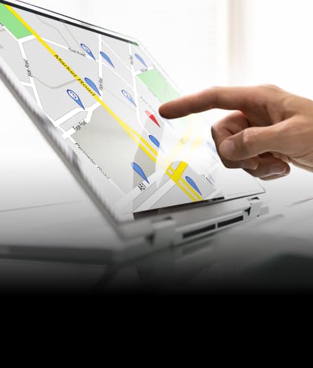 Person using a tablet with a map on screen.